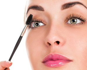 Eye makeup. Applying mascara on the lashes. Portrait of a woman close up
