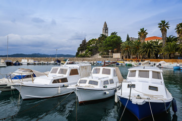Fototapeta na wymiar Harbor on Lopud Island with the Franciscan monastery on the background, Croatia
