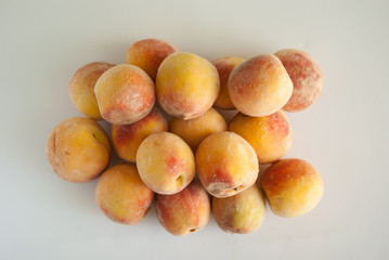 Peach fruit. Closeup view on grey background