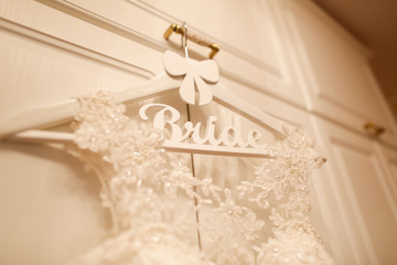 Fototapeta na wymiar wedding dress hanged on a white wardrobe