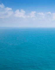 Obraz premium Abstract blurred background of blue sea and white cloud on sky with copy space.