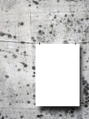 Close-up of one hanged blank frame with pegs against stained concrete wall background