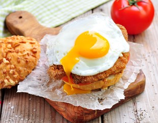 Sandwich with chicken schnitzel, tomato and egg