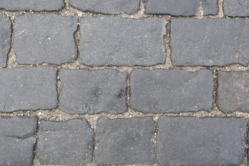 Stone blocks in the walkway,patterned paving tiles. Grey stone texture
