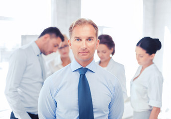 businessman in office with group on the back
