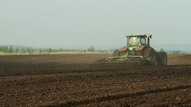 Harrowing the field by using agricultural modern machinary