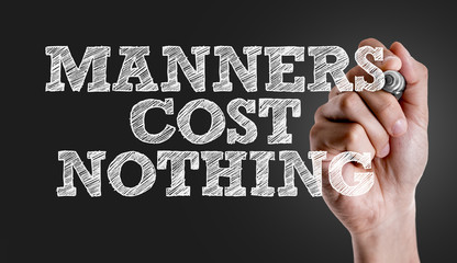 Hand writing the text: Manners Cost Nothing