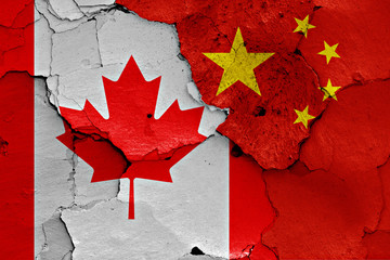 flags of Canada and China painted on cracked wall