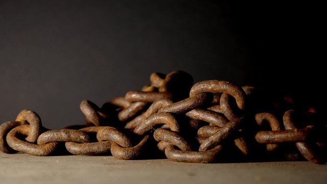 A rusty old chain falling to the floor