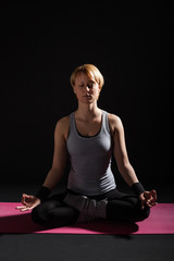 Young woman practicing yoga, Padmasana / Lotus Position