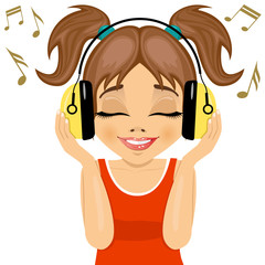little cute girl enjoys listening to music with headphones 