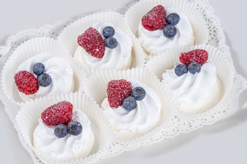 set of cakes with fresh blueberries and raspberries  in a box, s