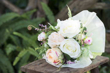 Roses and little hearts on wooden background