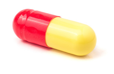 macro of red and yellow capsule pill isolated
