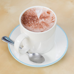 Hot chocolate in a white cup on  table