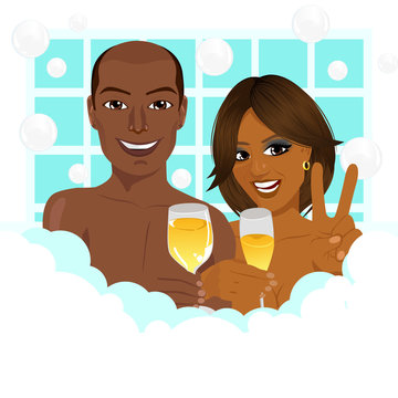 A young african american couple taking a bath with champagne