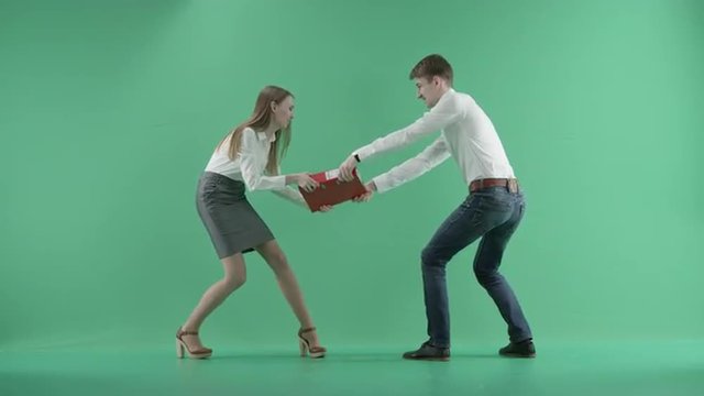 two businessmen fighting for red folder on a green screen