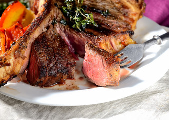 steak on a plate with grilled vegetables and sauce