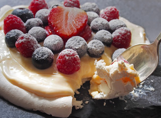 Pavlova meringue cake with cream and berries