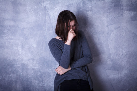 teen girl in studio posing on a dark background