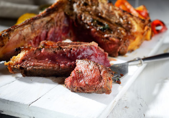 steak with grilled vegetables and sauce on a white background
