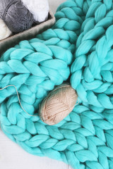 Knitted wool plaid  and clothes on light background