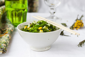 Chuka seaweed salad garnished with rice and corn