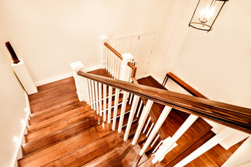 View of glossy wooden stairs from top showing the closed door