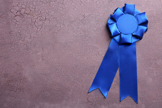 Award ribbon on wooden background