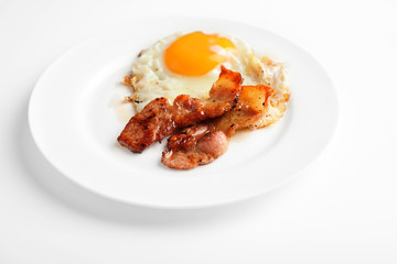 bacon and eggs on a white background