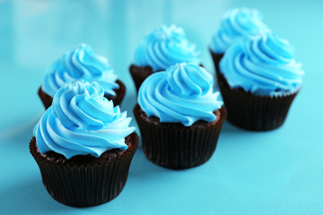 Chocolate cupcakes on blue background