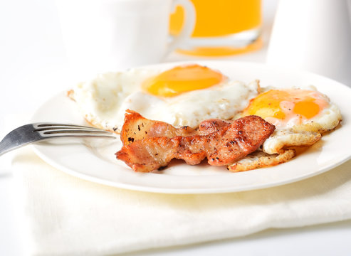 bacon and eggs on a white background
