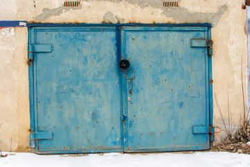 metal door of garage with lock. brick background