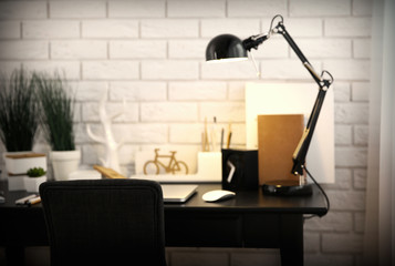 Workplace with laptop on table at home