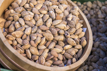 Almond nuts on wood tank in shop, background and texture