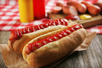 Hot dogs on wooden background closeup
