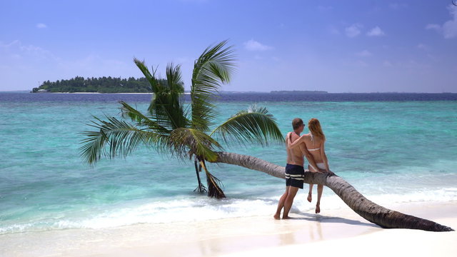 A couple in love kissing on a tropical beach. 4k