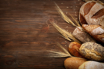 Fresh baked bread on the wooden background