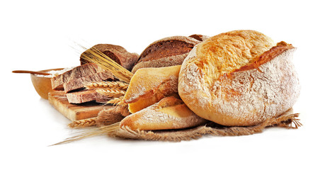 Fresh baked bread and wheat ears, isolated on white