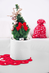 Small decorated Christmas tree on the table in the room, close up