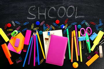 Back to school concept. Colourful stationery on black background