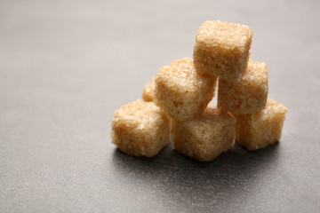 Pile of brown sugar cubes on the table