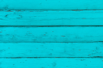 Natural wooden blue, turquoise boards, wall or fence with knots. Abstract textured background, empty template. Horizontal planks of wood, mint color