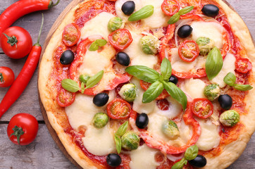 Delicious pizza with cheese and vegetables on wooden table closeup