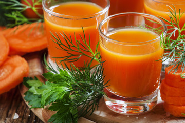 Freshly squeezed carrot juice in glasses, selective focus