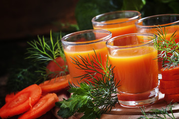 Freshly squeezed carrot juice in glasses, selective focus