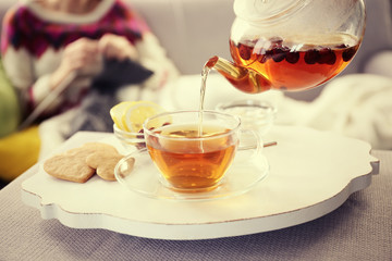 Pouring tea into cup, home atmosphere