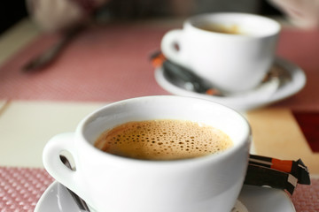 Cups of coffee on table in cafe, close up