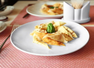 Tasty pancakes on plate in cafe, close up