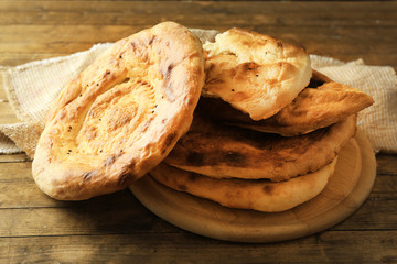 Flat bread on wooden mat on table